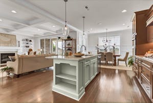 Home interior photo featuring popular design selections including shelving, a fireplace, medium hardwood, and wall paneling.